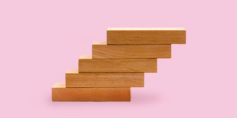 Wooden blocks on a pink background